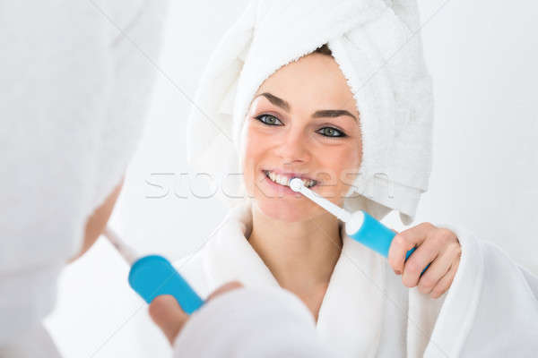 Nő fogmosás közelkép fürdőköpeny arc fogak Stock fotó © AndreyPopov