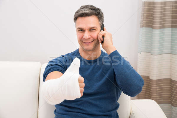 Man With Fractured Hand Showing Thumb-up Stock photo © AndreyPopov