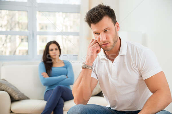 Defocused Woman In Front Of Sad Young Man Stock photo © AndreyPopov