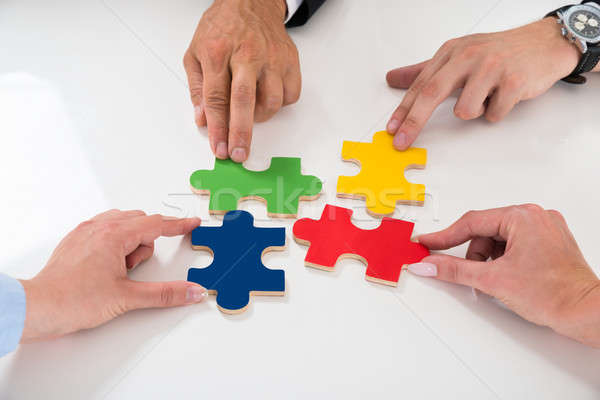 People Assembling Puzzle Pieces Stock photo © AndreyPopov