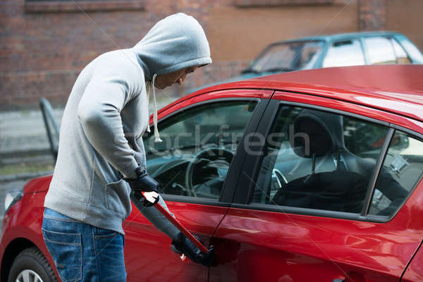 Thief Using Crowbar To Open Car's Door Stock photo © AndreyPopov