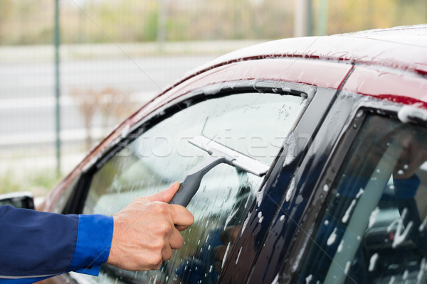 Serviceman Cleaning Car Window At Service Station Stock photo © AndreyPopov