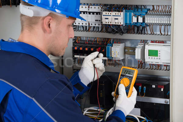 Male Technician Examining Fusebox Stock photo © AndreyPopov