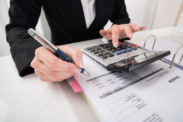 Businesswoman Hand Calculating Business Report Stock photo © AndreyPopov