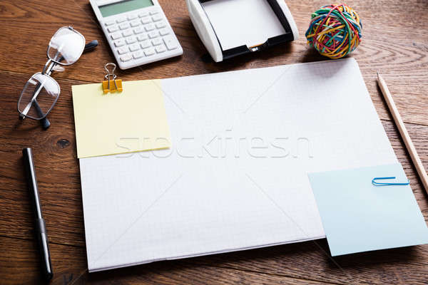 Stock photo: Paper Note Attached On Notebook With Paper Clips