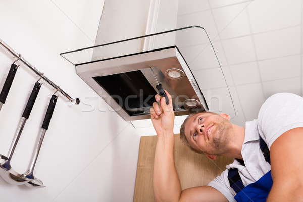 Young Male Technician Checking Kitchen Extractor Filter Stock photo © AndreyPopov