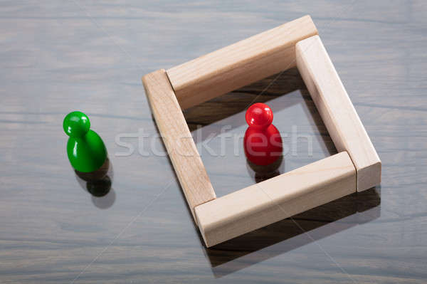 Green And Red Figurine Pawn On Desk Stock photo © AndreyPopov