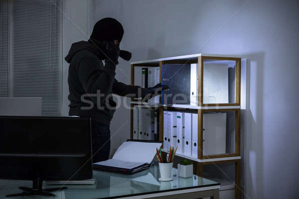 Thief Stealing File From Shelf Stock photo © AndreyPopov