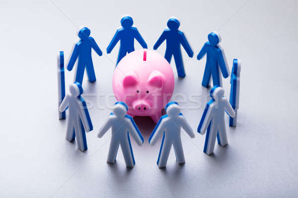 Human Figures Surrounding Pink Piggybank Stock photo © AndreyPopov