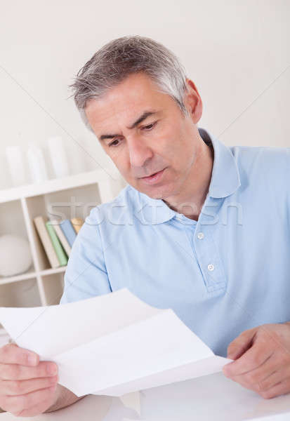 Horrified old man reading a letter Stock photo © AndreyPopov