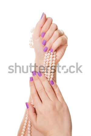 Close-up Of Woman's Hand Holding Pearl Necklace Stock photo © AndreyPopov
