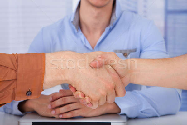 Businessmen Shaking Hands In Office Stock photo © AndreyPopov