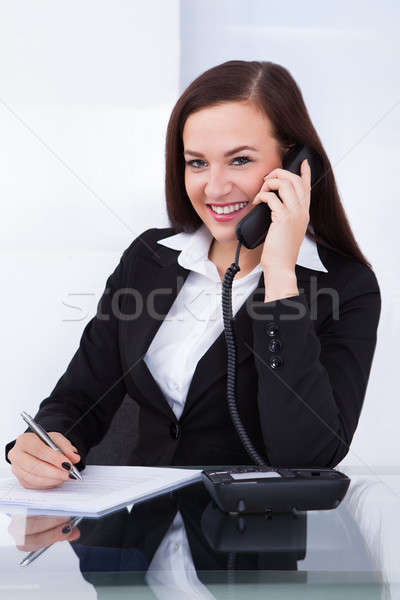 Businesswoman Using Telephone At Desk Stock photo © AndreyPopov