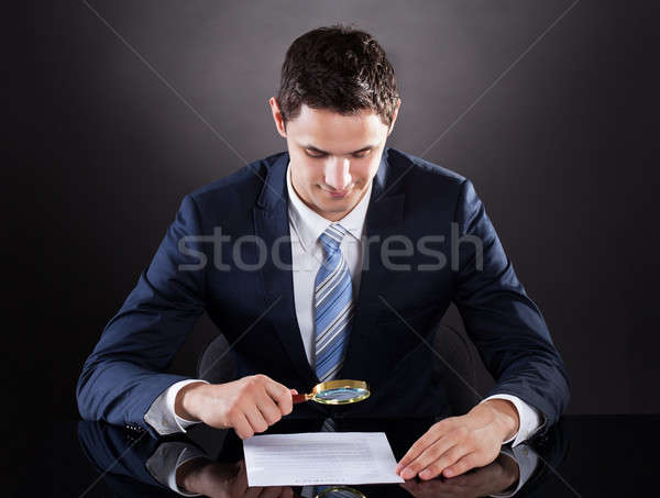 Stock photo: Businessman Examining Contract Paper With Magnifying Glass