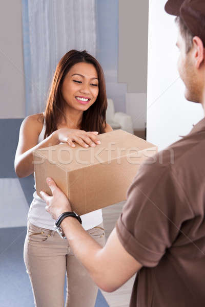 Woman Receiving Courier From Delivery Man Stock photo © AndreyPopov