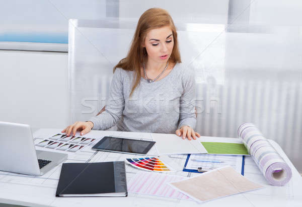 Young Woman Working At Office Desk Stock photo © AndreyPopov