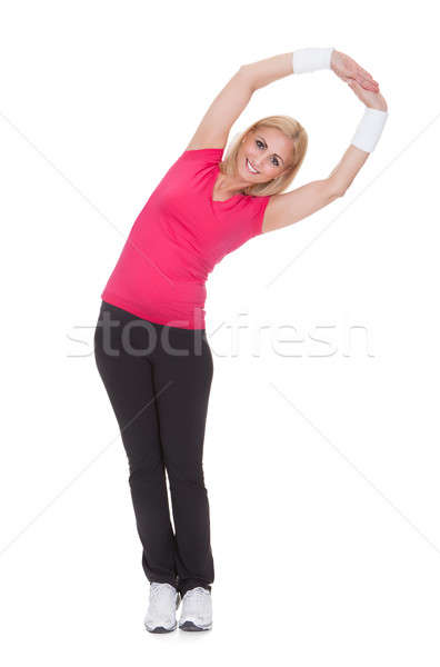 Portrait Of Happy Woman Doing Stretching Exercise Stock photo © AndreyPopov