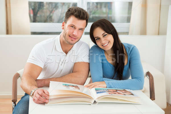 Happy Couple With Photo Album Stock photo © AndreyPopov