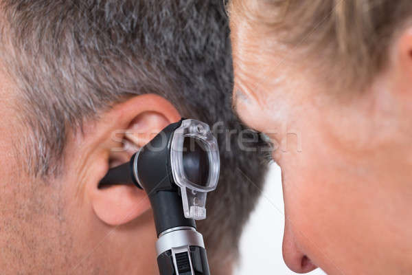 Doctor Examining Patient's Ear Stock photo © AndreyPopov