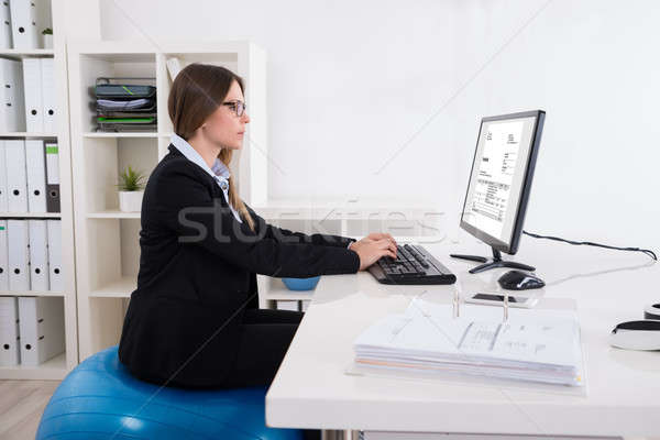Businesswoman Sitting On Pilates Ball Using Computer Stock photo © AndreyPopov