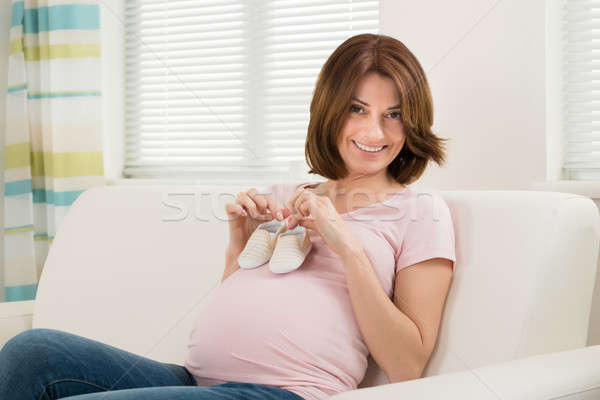 Pregnant Woman Holding Small Shoes For Unborn Baby Stock photo © AndreyPopov