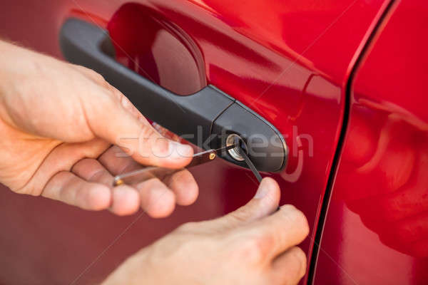 Person Opening Car Door With Lockpicker Stock photo © AndreyPopov