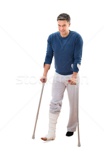 Disabili uomo stampelle piedi ritratto bianco Foto d'archivio © AndreyPopov