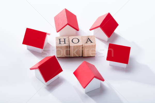 Homeowner Association Wooden Block Surrounded With House Models Stock photo © AndreyPopov