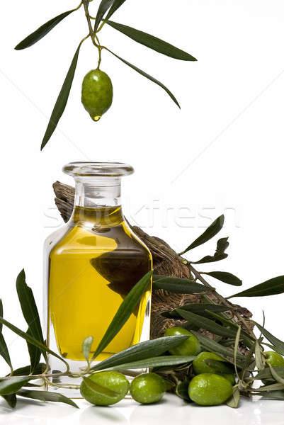 Olive oil dripping into a bottle. Stock photo © angelsimon