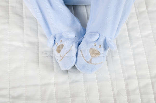 Closeup of a baby wearing rompers body in bed Stock photo © anmalkov