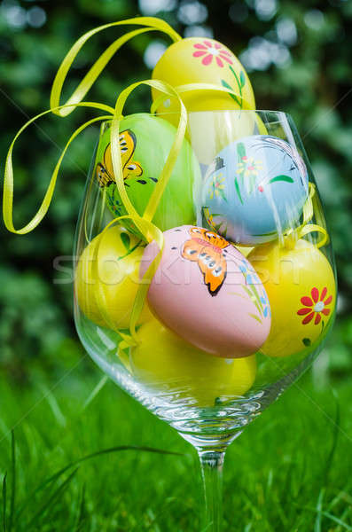 Painted easter eggs in glass on green grass Stock photo © anmalkov