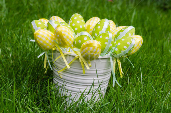 Easter eggs in white pail on grass Stock photo © anmalkov