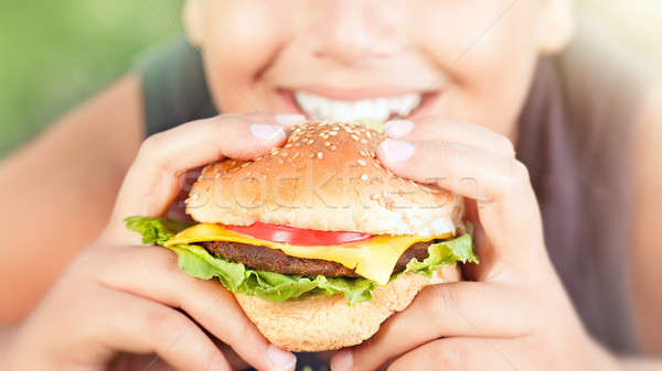 Happy teen boy eating burger Stock photo © Anna_Om