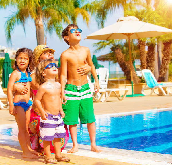 Familia feliz piscina cute lujo tropicales Foto stock © Anna_Om