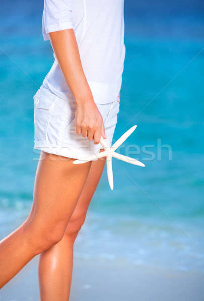 Woman with starfish on the beach Stock photo © Anna_Om