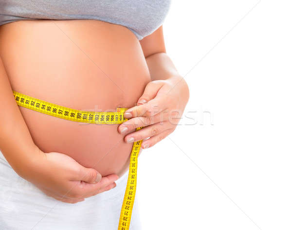 Expectant woman measuring abdomen Stock photo © Anna_Om