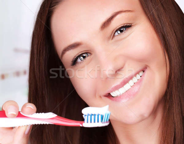Cute woman clean teeth Stock photo © Anna_Om