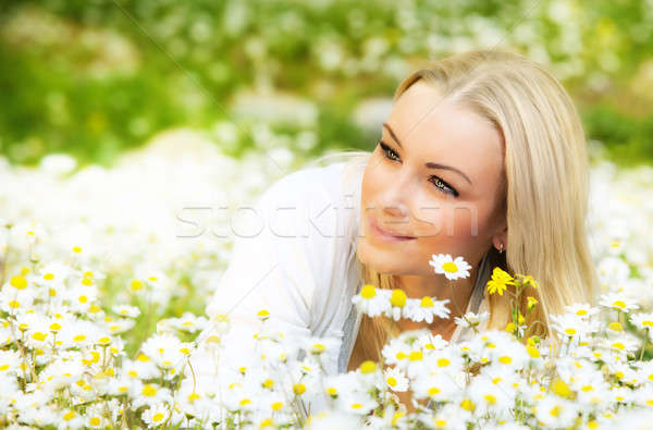 Beautiful female laying on the flower filed Stock photo © Anna_Om