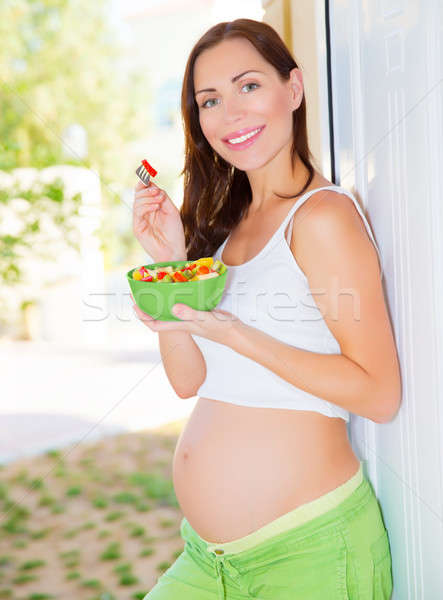 Expectant young lady eat salad Stock photo © Anna_Om