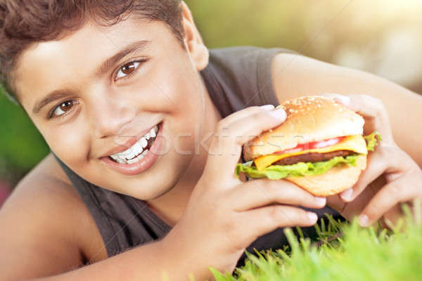 Happy boy eating burger Stock photo © Anna_Om