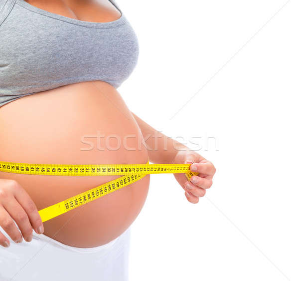 Pregnant female measuring belly Stock photo © Anna_Om
