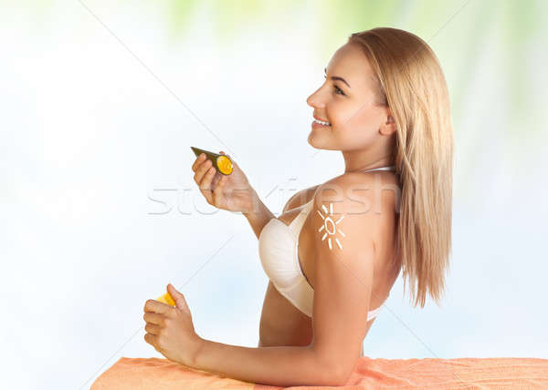 Beautiful girl using sunscreen Stock photo © Anna_Om
