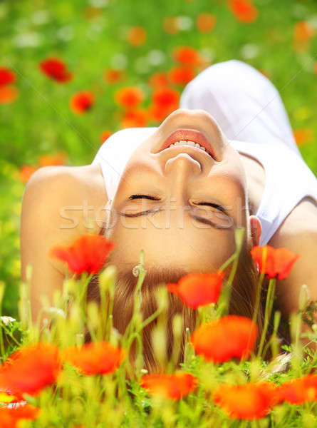 Beautiful female laying on the flower filed Stock photo © Anna_Om
