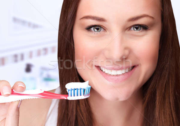Attractive female clean teeth Stock photo © Anna_Om
