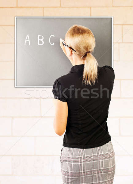 Young teacher write on blackboard Stock photo © Anna_Om