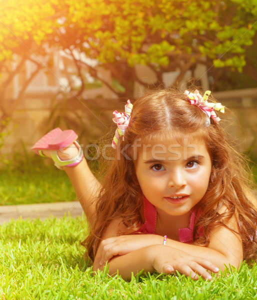 Little girl lying down on green grass Stock photo © Anna_Om
