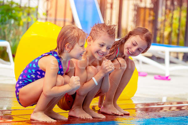 Heureux enfants piscine trois séance [[stock_photo]] © Anna_Om