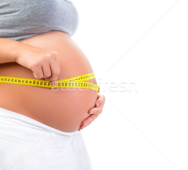 Stock photo: Expectant female measuring tummy