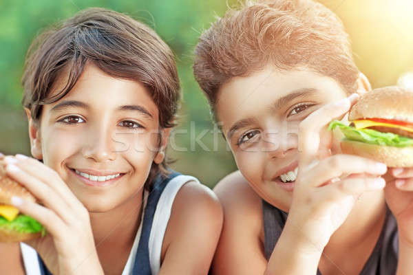 Happy boys eating burgers Stock photo © Anna_Om