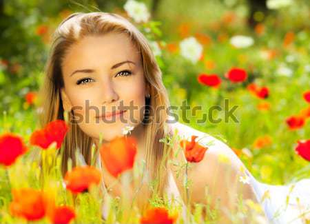 Beautiful female laying on the flower filed Stock photo © Anna_Om